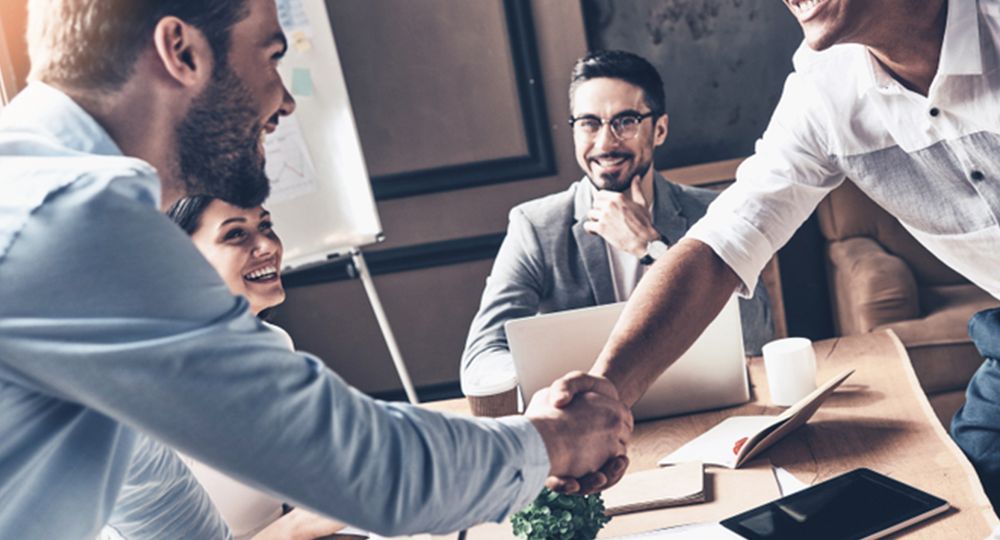 Colleagues congratulating, smiling